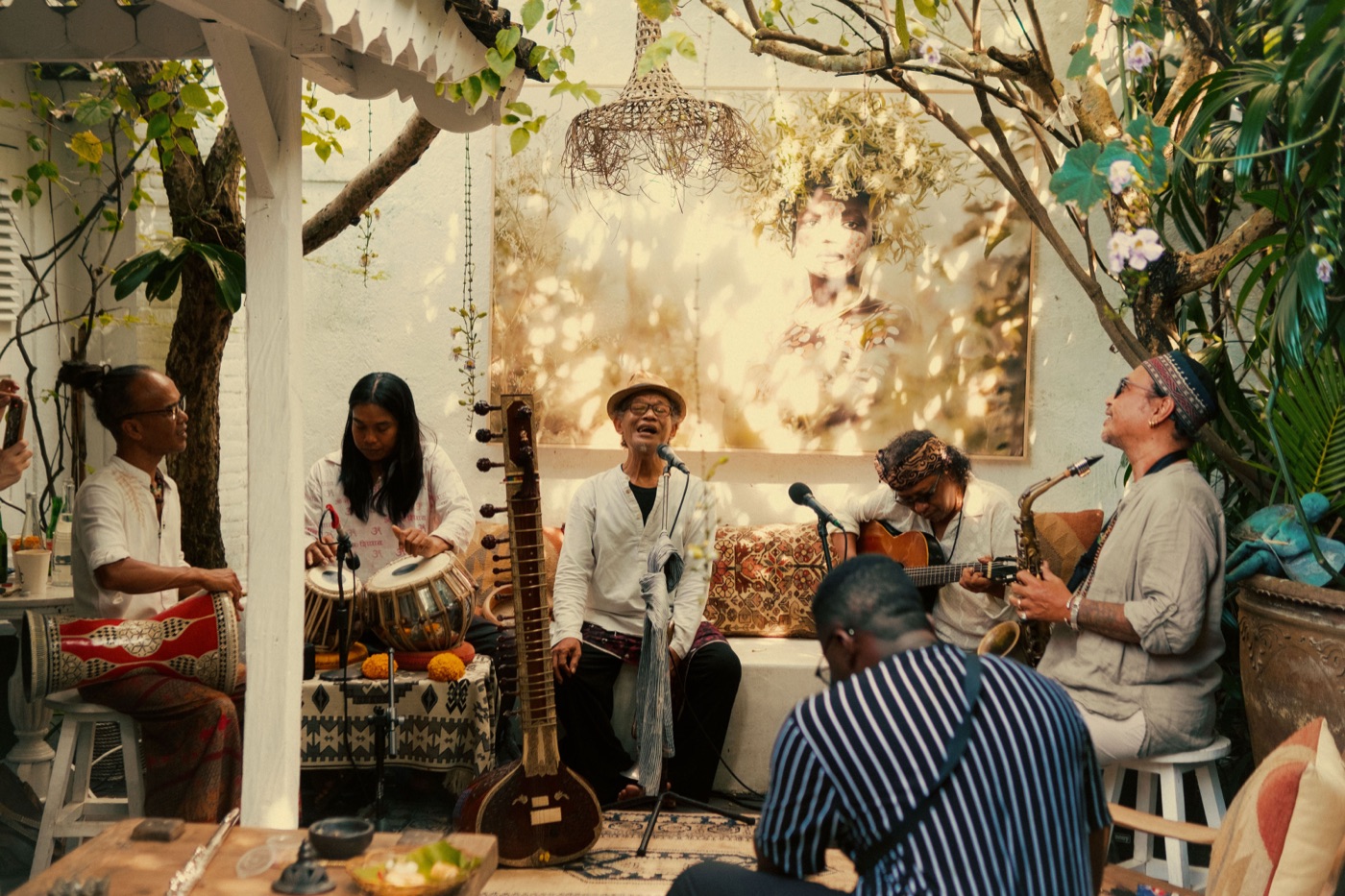 Live set at the launch — sitar, tabla, guitar and saxophone beneath a 54 Mag print