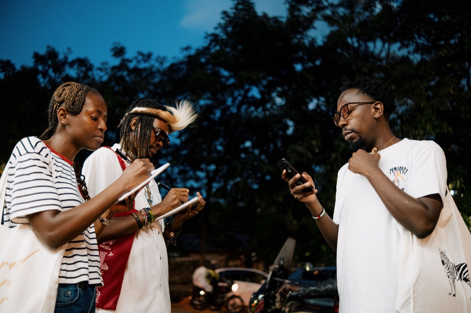 Nairobi Sketch Tour — sketchbooks open on the street at dusk