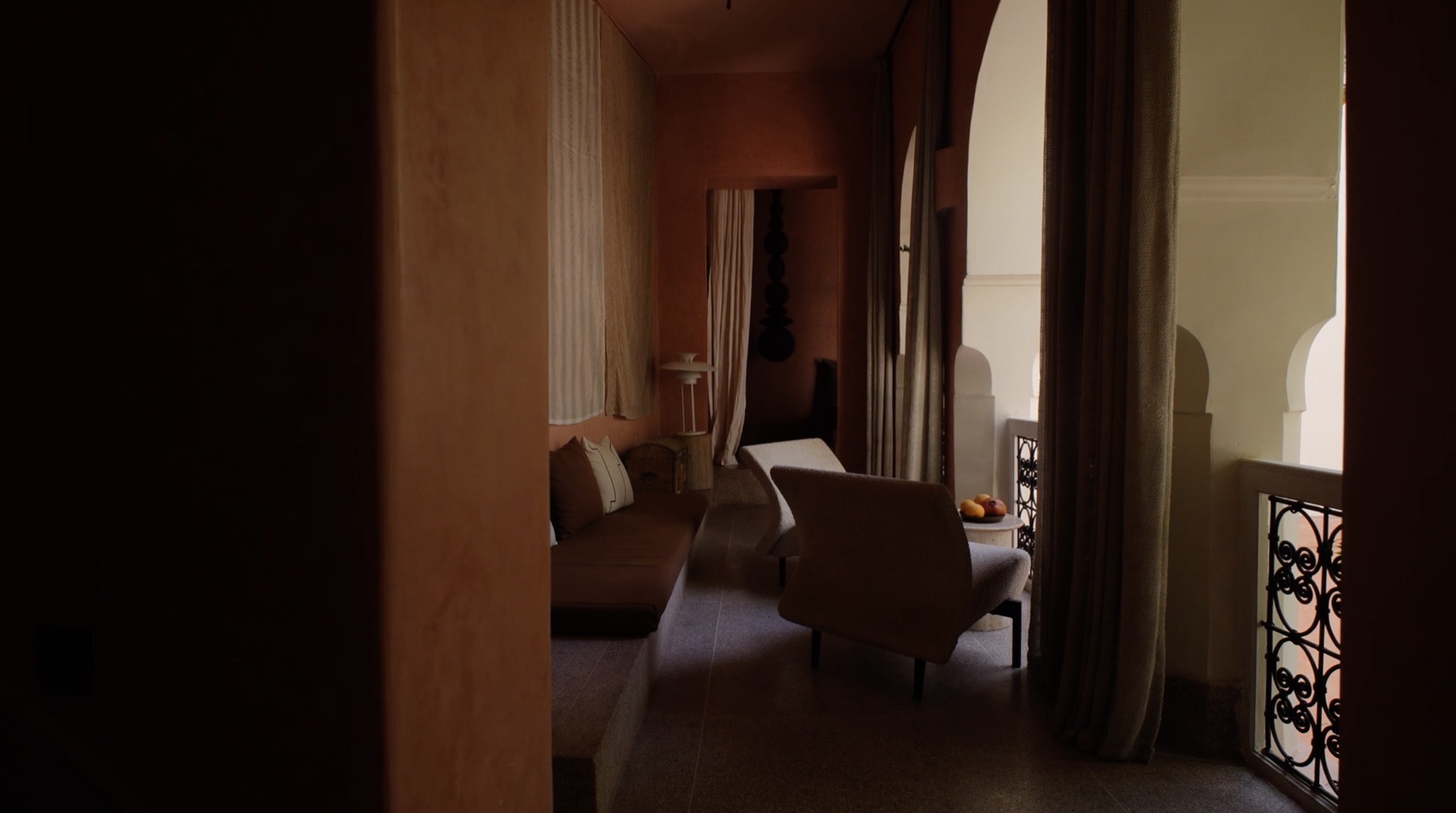 Riad Brummell Medina — warm tadelakt corridor opening onto an arched balcony